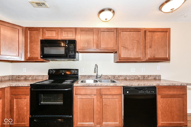 kitchen featuring sink and black appliances