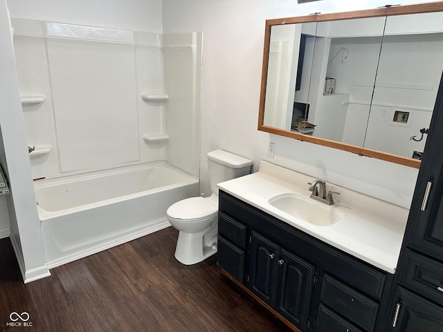 full bathroom featuring vanity, hardwood / wood-style flooring, toilet, and tub / shower combination