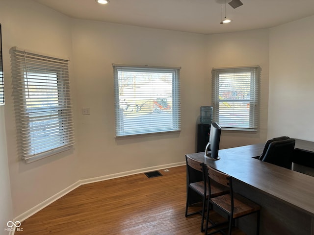 office featuring hardwood / wood-style floors, plenty of natural light, and ceiling fan