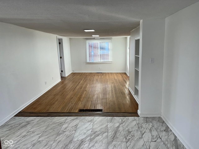 spare room featuring a textured ceiling