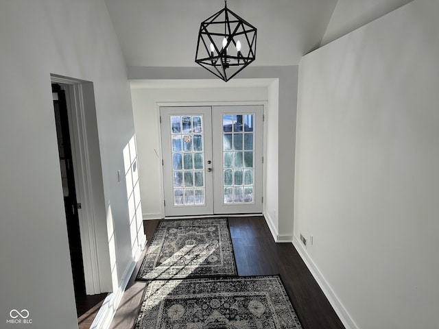 doorway featuring french doors, dark hardwood / wood-style floors, and a notable chandelier