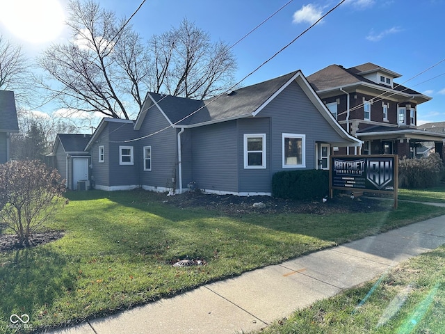 view of property exterior with central AC and a lawn