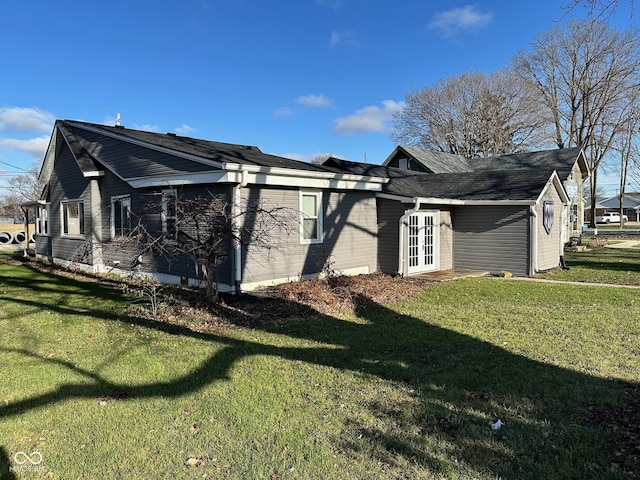 view of side of property with a yard and french doors