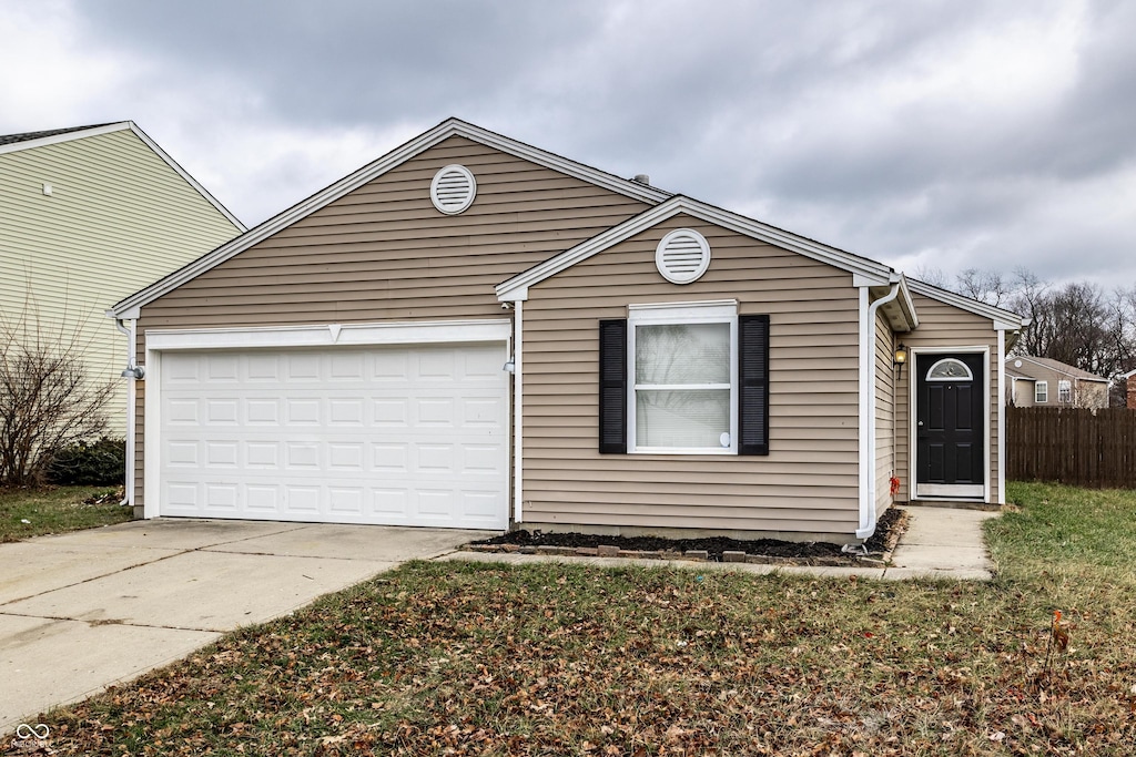 view of front of house featuring a garage and a front lawn