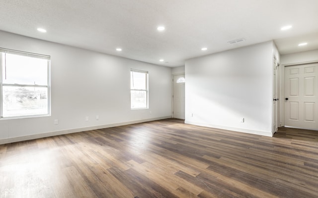 empty room with dark hardwood / wood-style floors