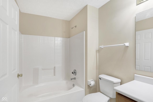 full bathroom with vanity, toilet, a textured ceiling, and bathing tub / shower combination