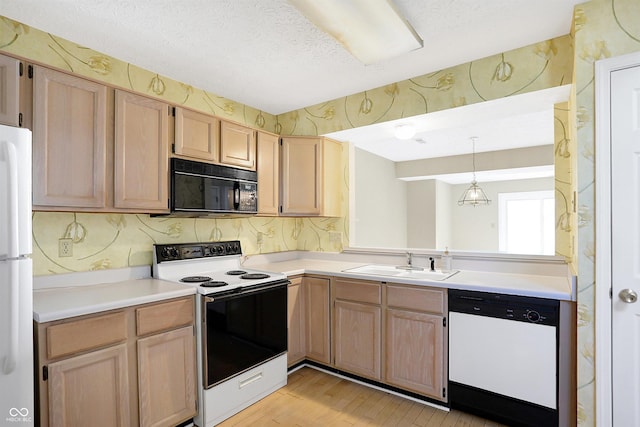 kitchen featuring sink, light brown cabinets, pendant lighting, a textured ceiling, and white appliances