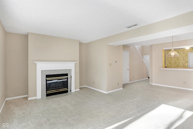 unfurnished living room featuring light carpet and a fireplace