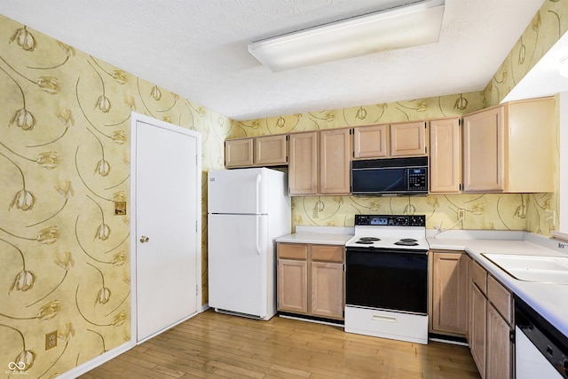 kitchen with dishwasher, a textured ceiling, white fridge, and electric stove