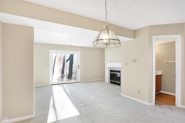 unfurnished living room with a notable chandelier and light colored carpet