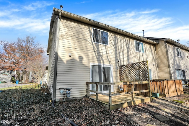 back of house with a wooden deck