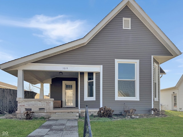 view of front of home with a porch and a front lawn