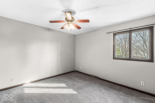 carpeted spare room featuring a textured ceiling and ceiling fan