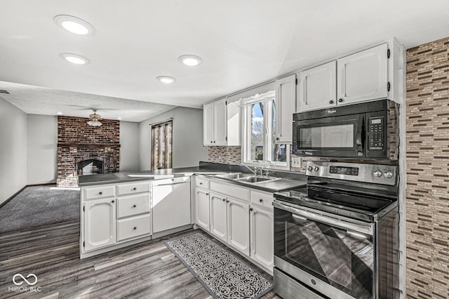 kitchen with stainless steel electric range, dishwasher, kitchen peninsula, decorative backsplash, and white cabinetry