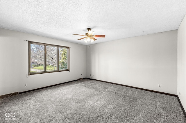 unfurnished room with ceiling fan, carpet, and a textured ceiling