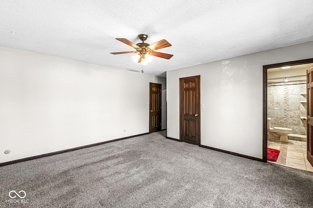 spare room featuring ceiling fan, light colored carpet, and a textured ceiling