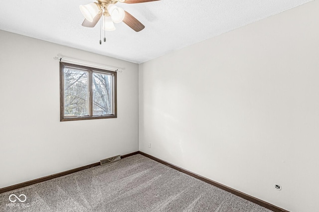 carpeted empty room with a textured ceiling and ceiling fan