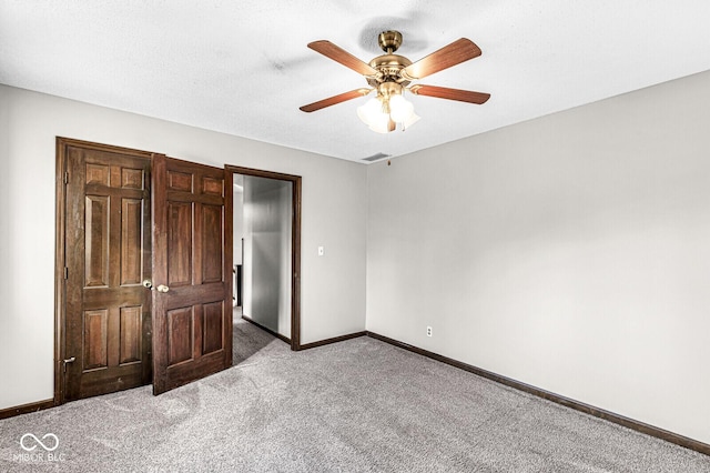 unfurnished bedroom featuring ceiling fan and carpet floors