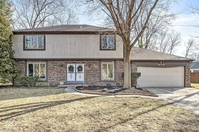 view of front of property featuring brick siding, driveway, and a garage