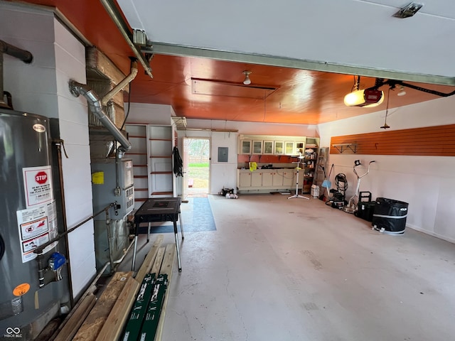 garage featuring water heater, a garage door opener, and electric panel