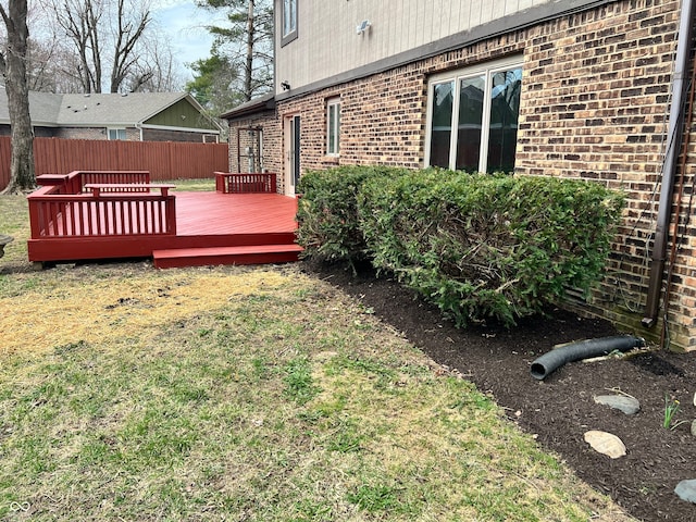 view of yard featuring fence and a wooden deck