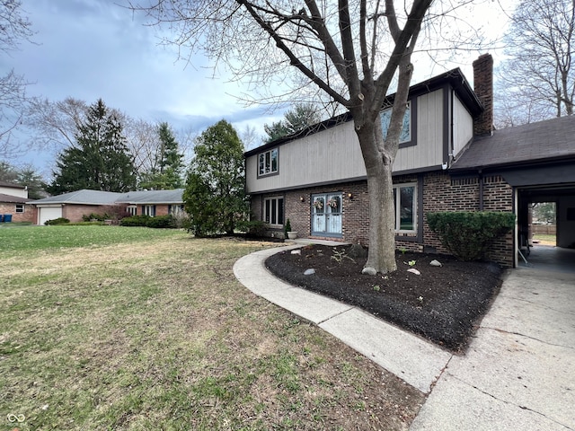 view of front of house featuring a chimney, concrete driveway, a front yard, and brick siding