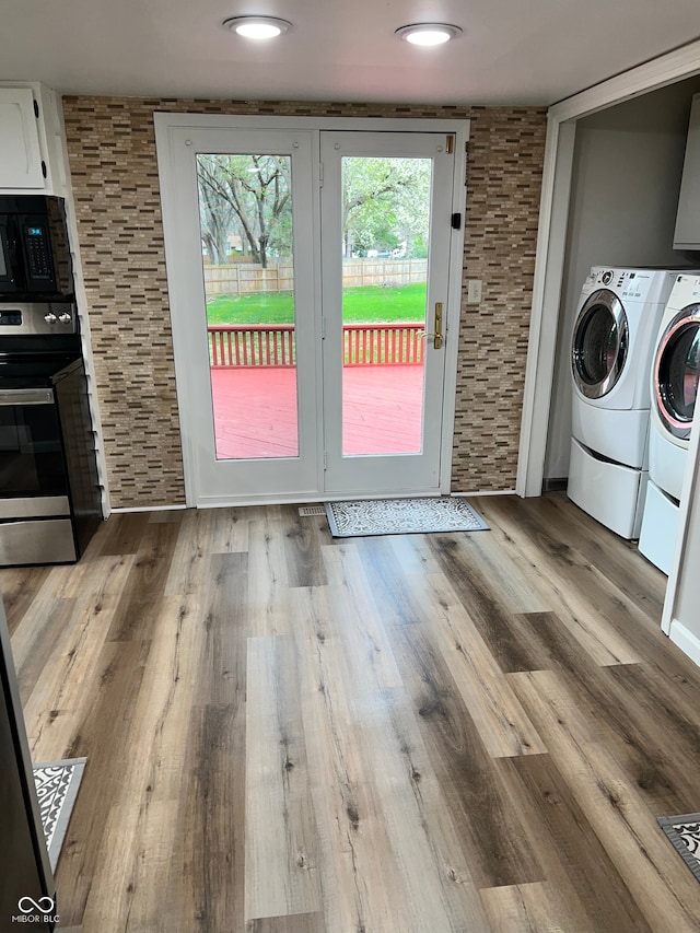 doorway featuring washing machine and dryer and wood finished floors