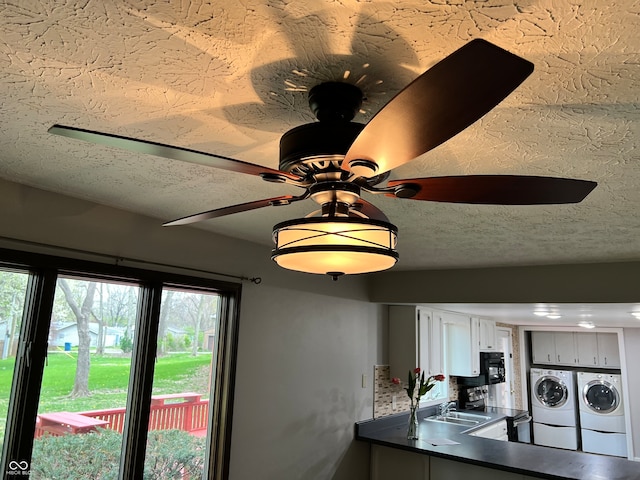 details with a sink, ceiling fan, dark countertops, a textured ceiling, and washing machine and clothes dryer