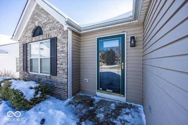 view of snow covered property entrance