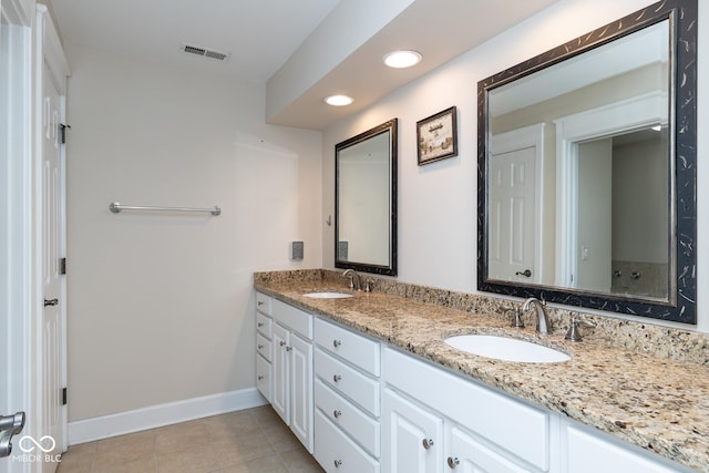 bathroom with tile patterned floors and vanity