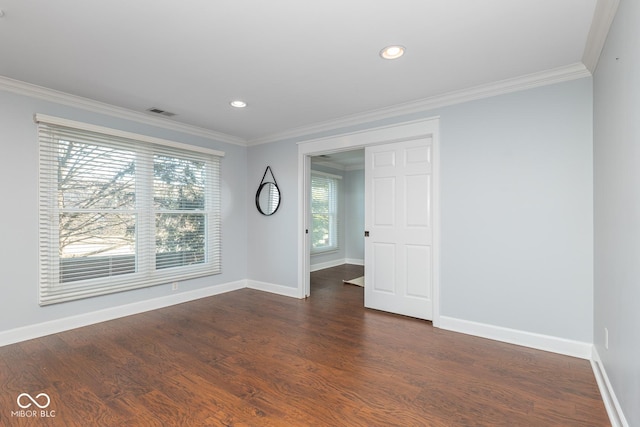 spare room featuring dark hardwood / wood-style floors and ornamental molding