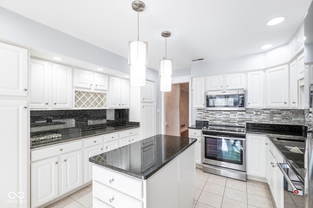 kitchen featuring decorative backsplash, white cabinetry, and stainless steel appliances