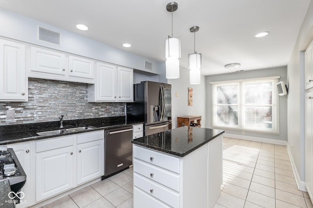 kitchen with pendant lighting, white cabinetry, sink, and appliances with stainless steel finishes