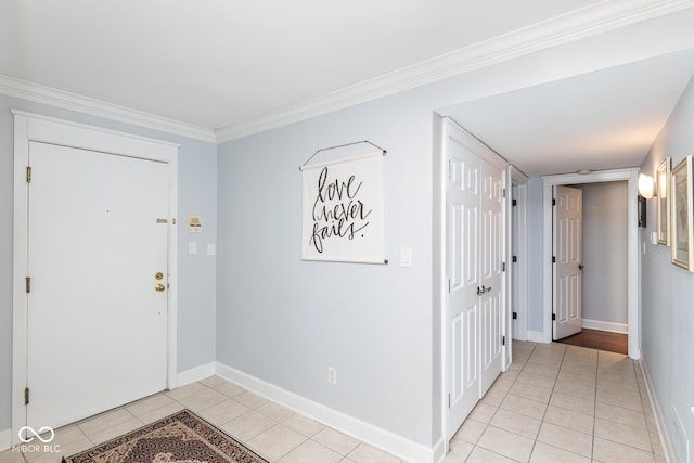 entryway with light tile patterned floors and crown molding