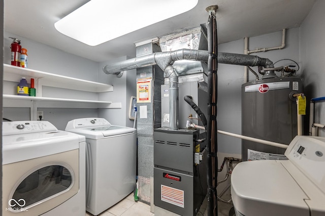 laundry area featuring gas water heater, separate washer and dryer, and light tile patterned floors