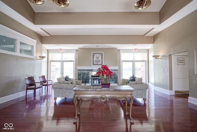 living room featuring a wealth of natural light and dark hardwood / wood-style flooring