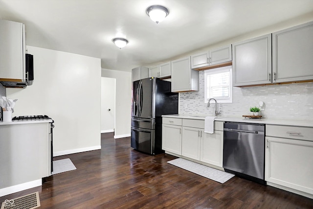 kitchen with dishwasher, sink, dark wood-type flooring, black refrigerator with ice dispenser, and gray cabinets