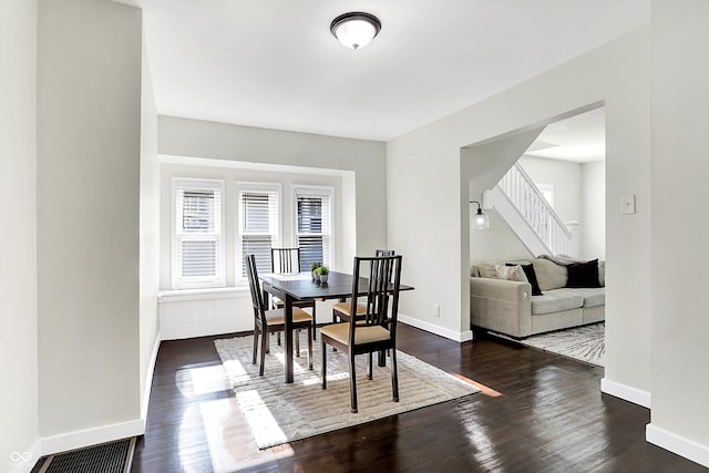 dining area with dark wood-type flooring