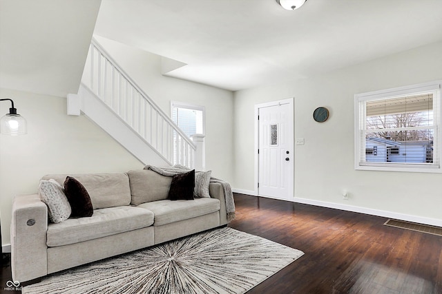 living room featuring wood-type flooring and a wealth of natural light