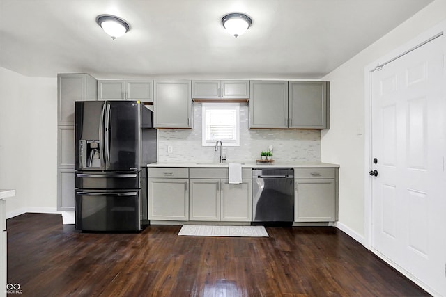 kitchen featuring dark hardwood / wood-style flooring, stainless steel appliances, gray cabinets, and sink