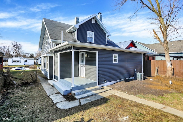 rear view of property with central AC