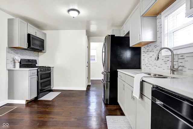 kitchen with backsplash, stainless steel appliances, dark hardwood / wood-style floors, and sink