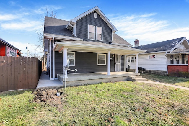 view of front facade with covered porch and a front yard