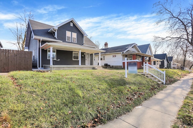 view of front of property with covered porch and a front yard