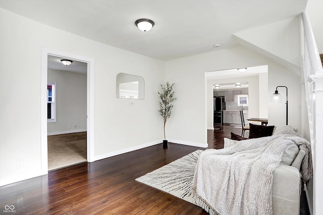 interior space with black refrigerator and dark hardwood / wood-style flooring