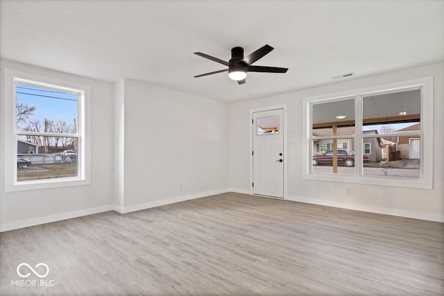 spare room with wood-type flooring and ceiling fan