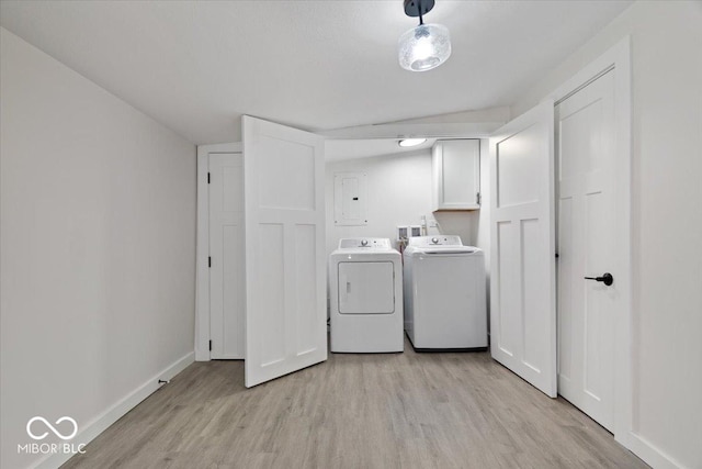 laundry room featuring light hardwood / wood-style flooring, cabinets, and independent washer and dryer