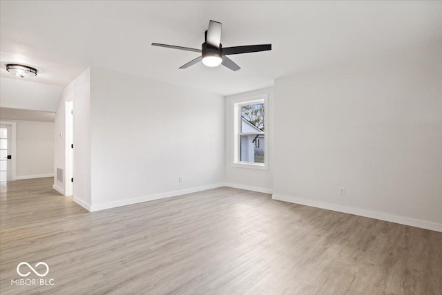 spare room with ceiling fan, light hardwood / wood-style floors, and vaulted ceiling