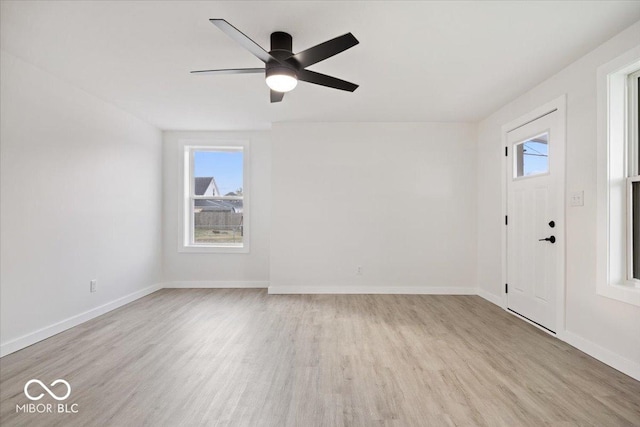 entrance foyer with ceiling fan and light hardwood / wood-style flooring