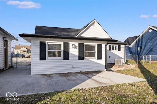 rear view of house with a patio and central AC